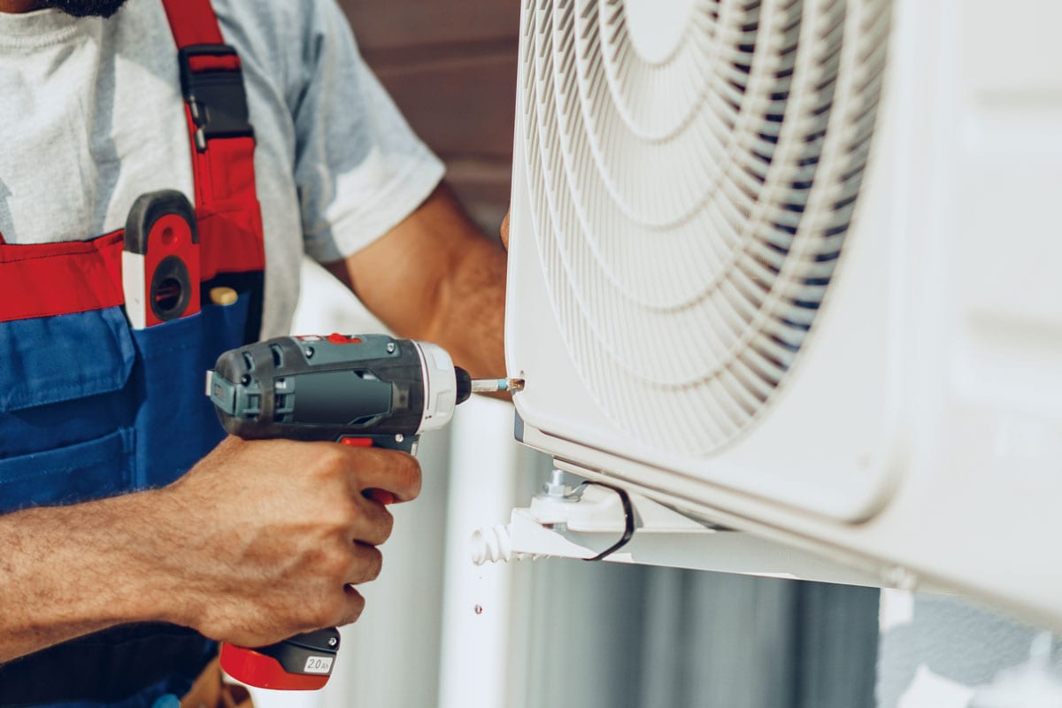 Professional mechanic installing the outside unit ac