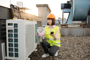 Woman using checking tool for work with air condit utc | Dr. Ductless Heating & Cooling