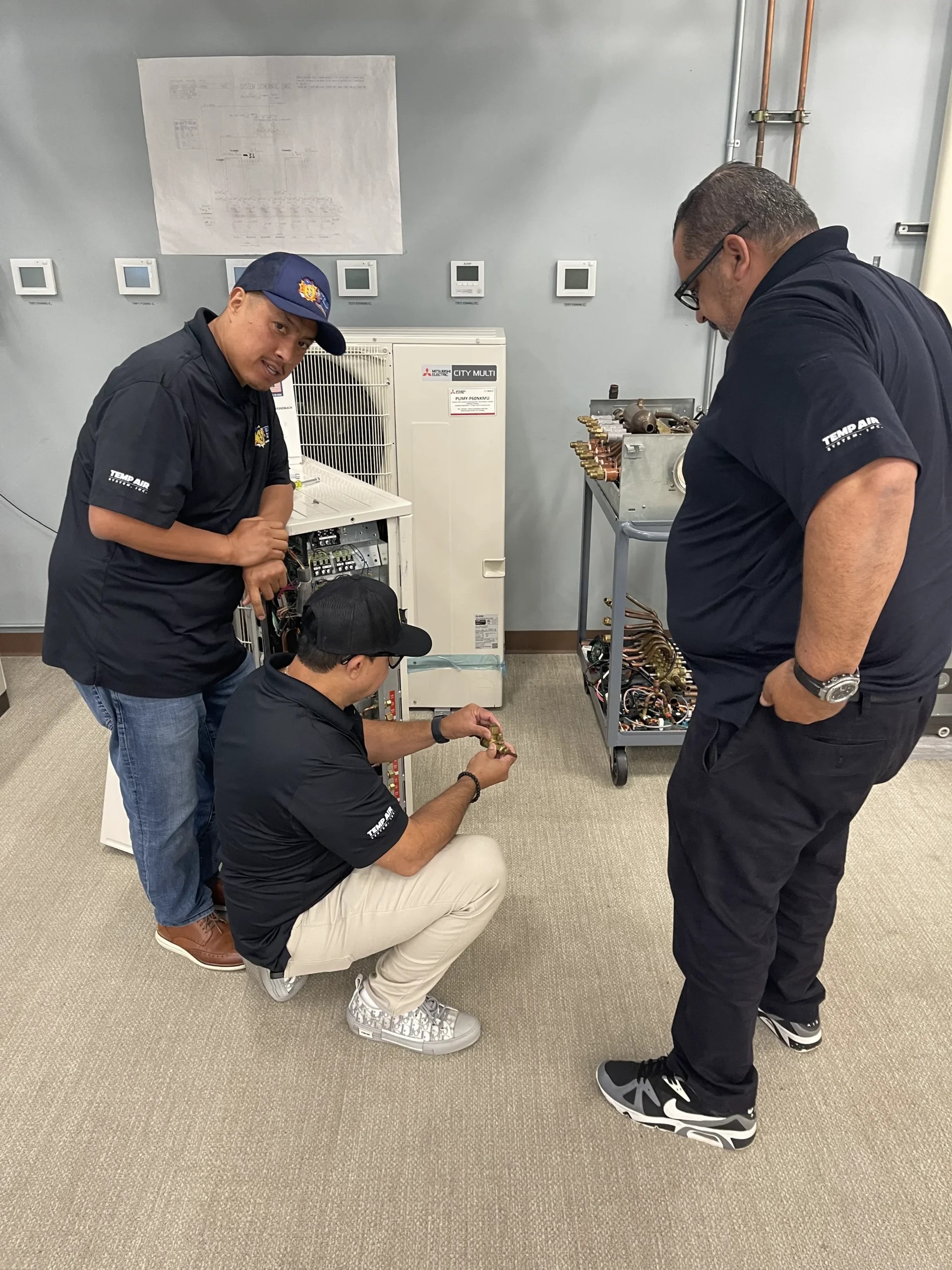 Technicians working on a HVAC system.