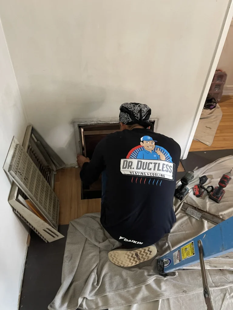 Technician working in customer house | Dr. Ductless Heating & Cooling